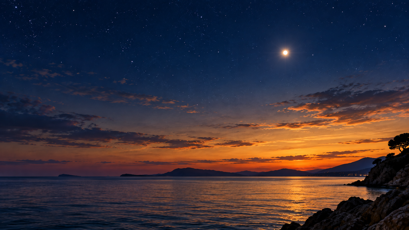 Bright Venus shines above a tranquil sea at twilight, with deep blue stars overhead and warm golden light glowing along the distant horizon.